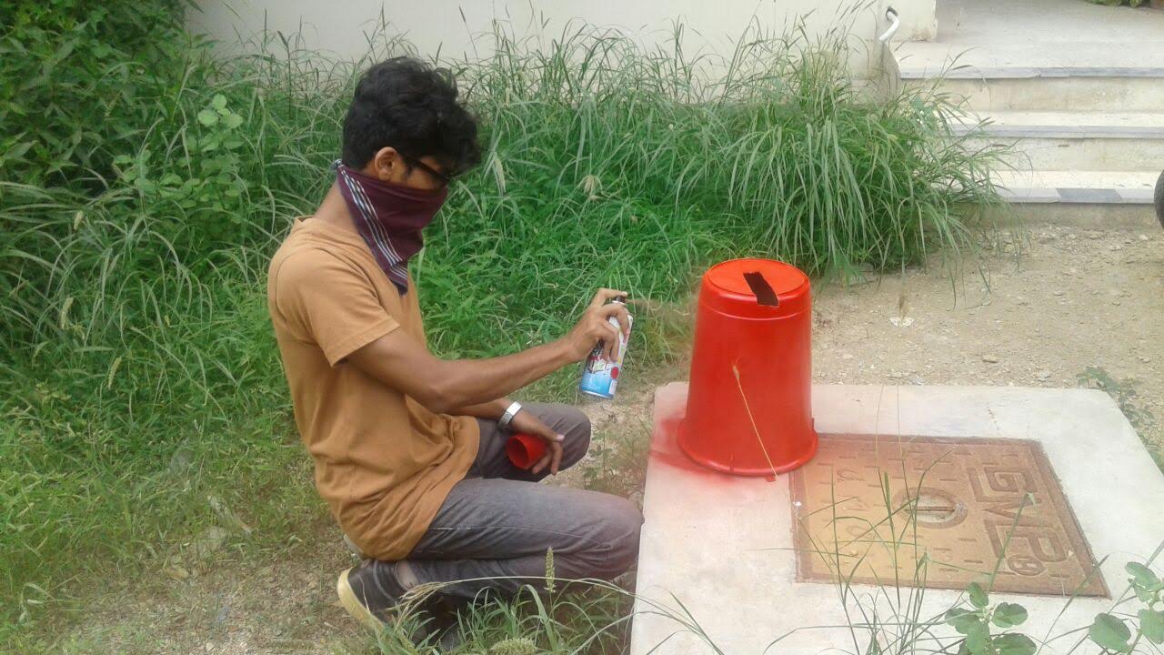 Spray painting a trashcan that became the body of the first Chotu