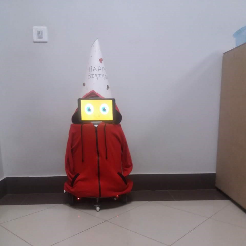Robo-Chotu weraing a birthday hat and happy